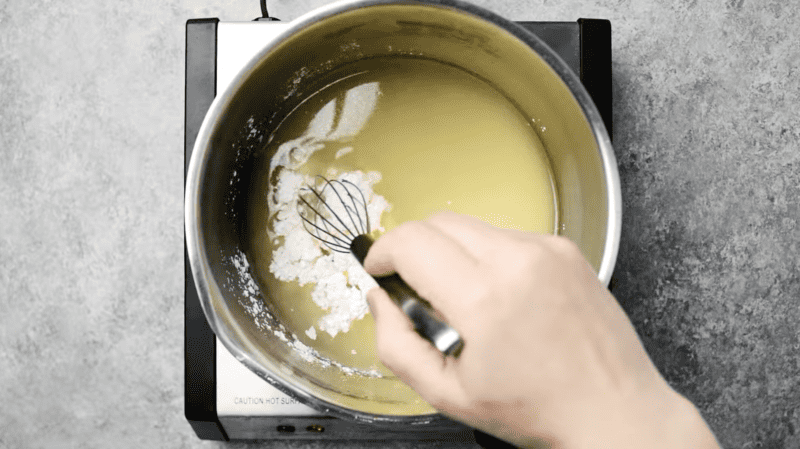 lemon juice with cornstarch in a saucepan with a whisk.