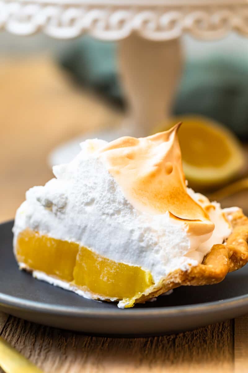 slice of lemon meringue pie on grey plate
