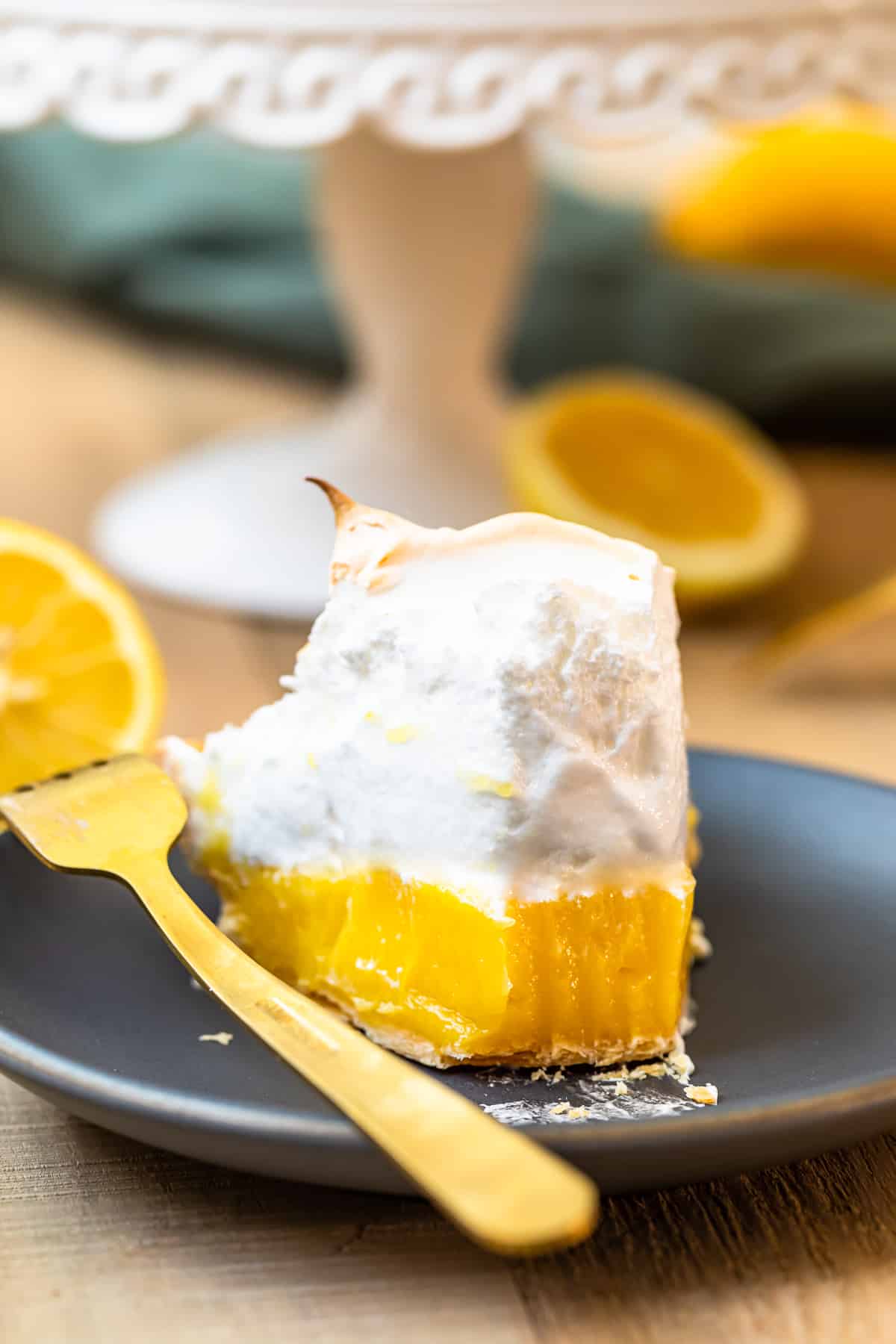 slice of lemon meringue pie with bite out