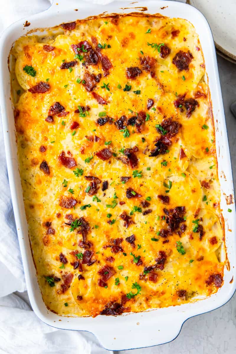 loaded scalloped potatoes in baking dish
