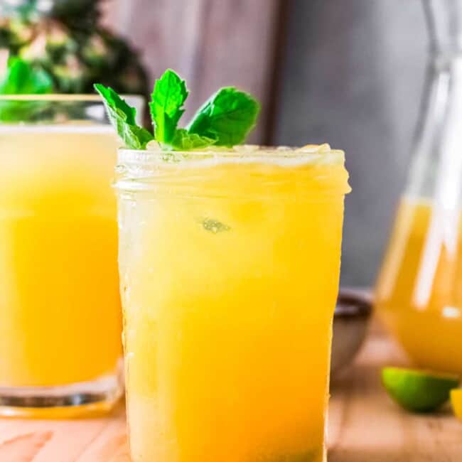pineapple agua fresca in glass garnished with mint