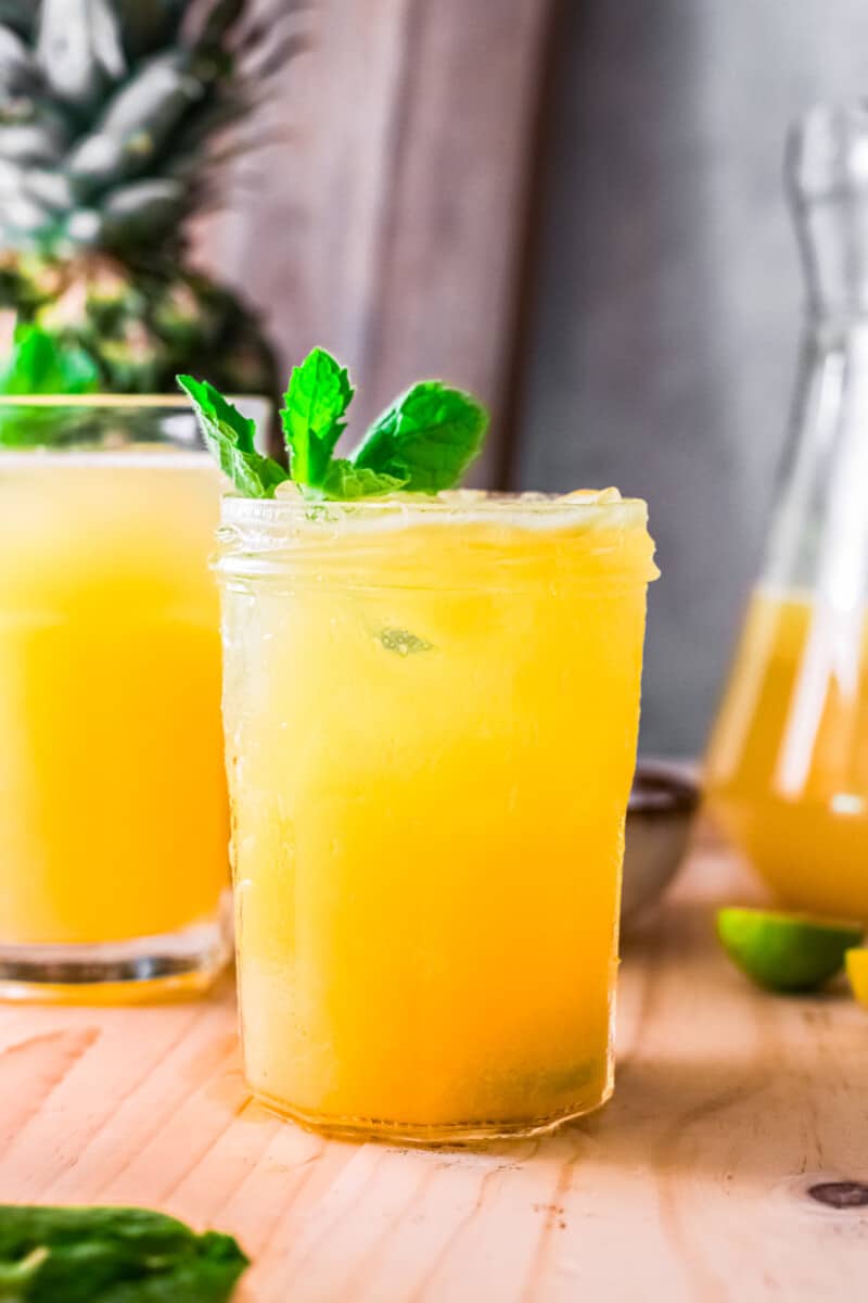 pineapple agua fresca in glass garnished with mint