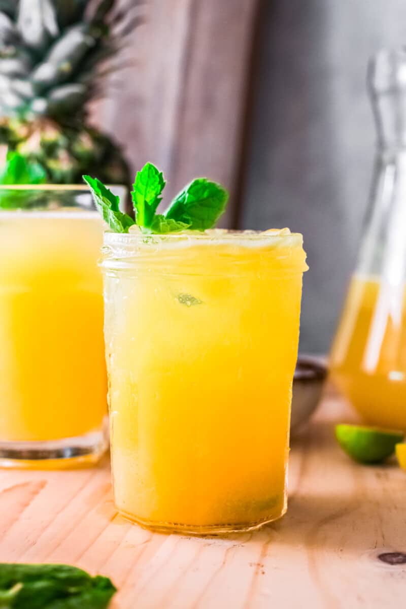 pineapple agua fresca in glass garnished with mint