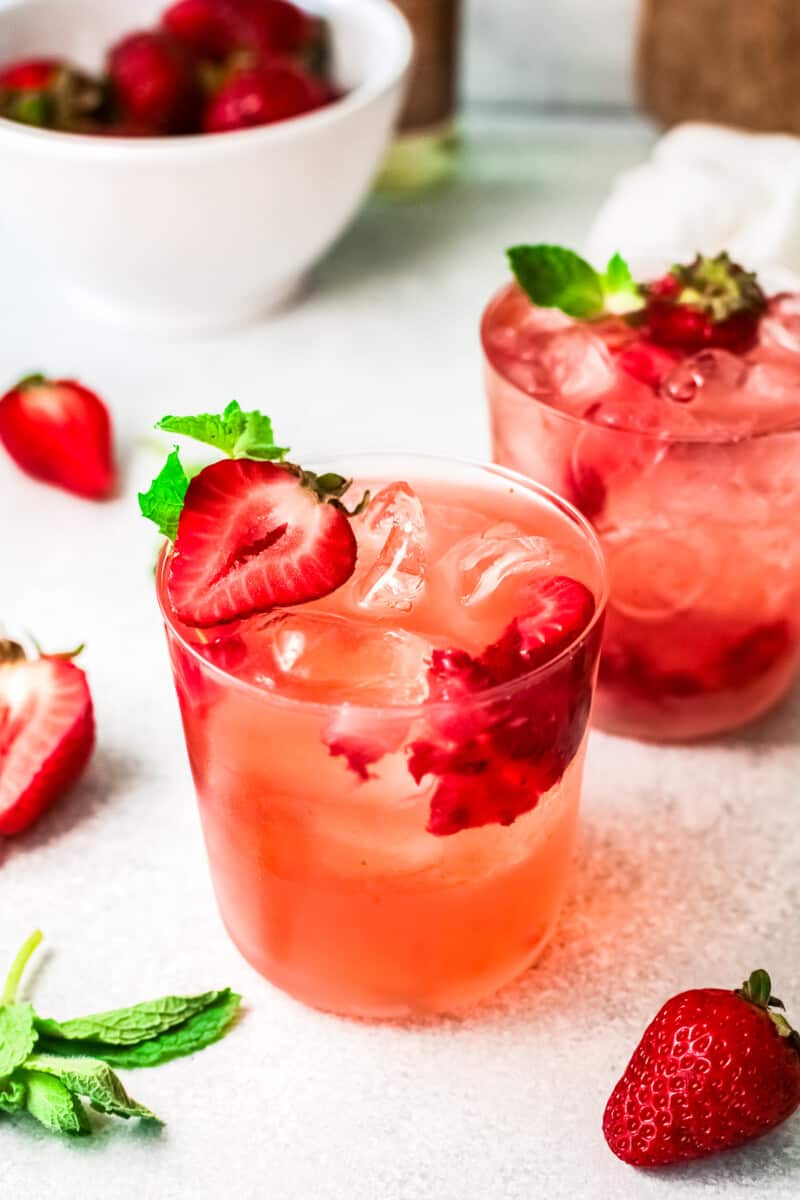 two glasses with strawberry palomas