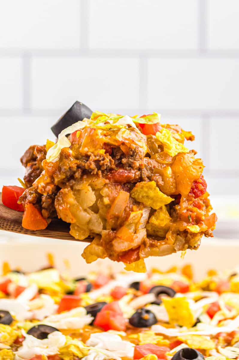 wooden spoon lifting up taco casserole