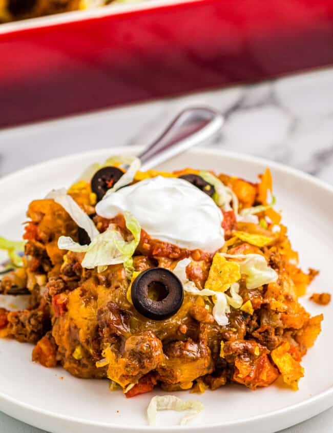 taco casserole on plate garnished with sour cream