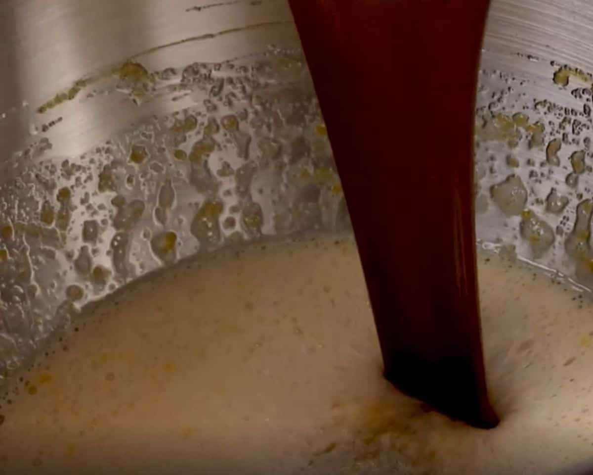 Pouring the melted chocolate into the eggs, sugar, and vanilla.  - 5