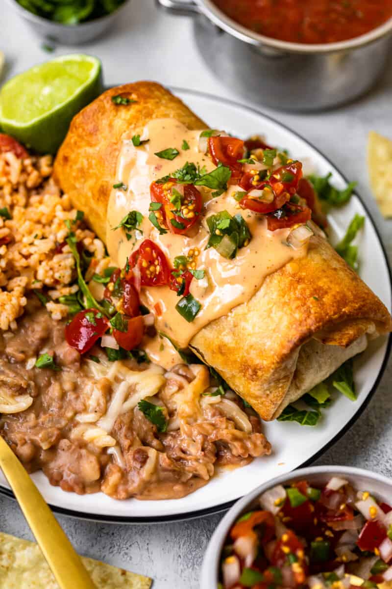 queso topped chicken chimichanga on plate