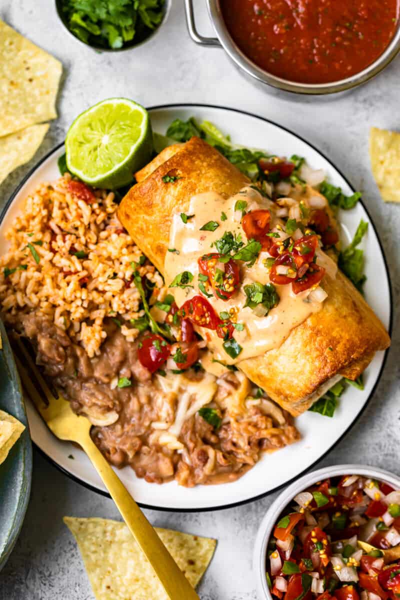 queso topped chicken chimichanga on plate