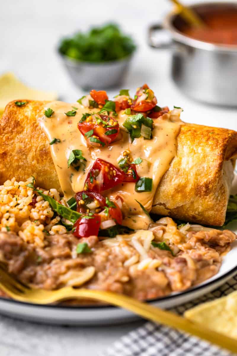 baked chicken chimichanga topped with queso and pico