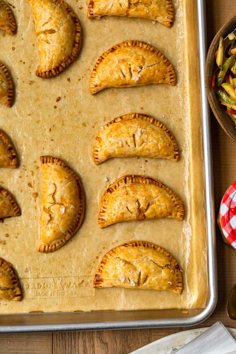 chicken empanadas on baking sheet