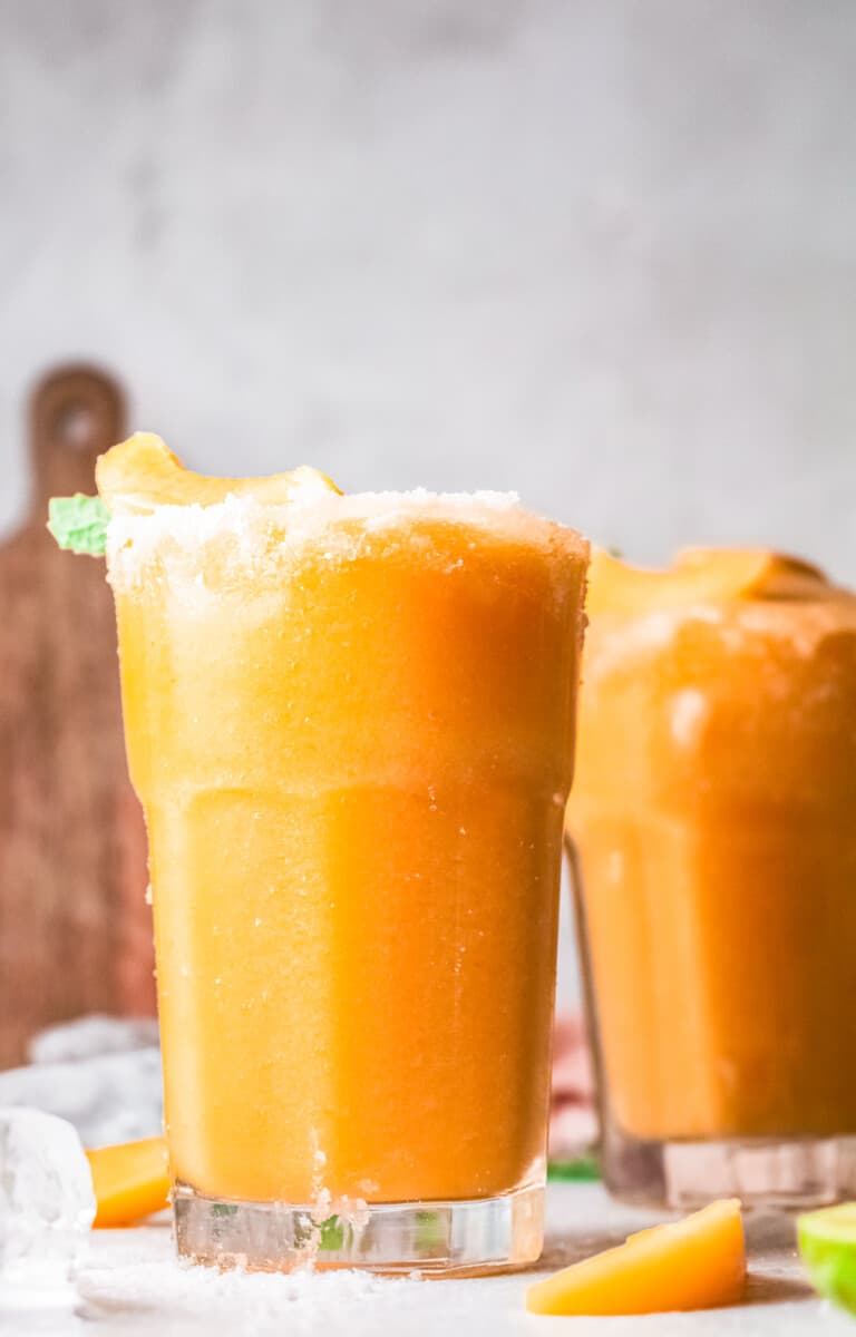 two glasses of frozen peach margaritas