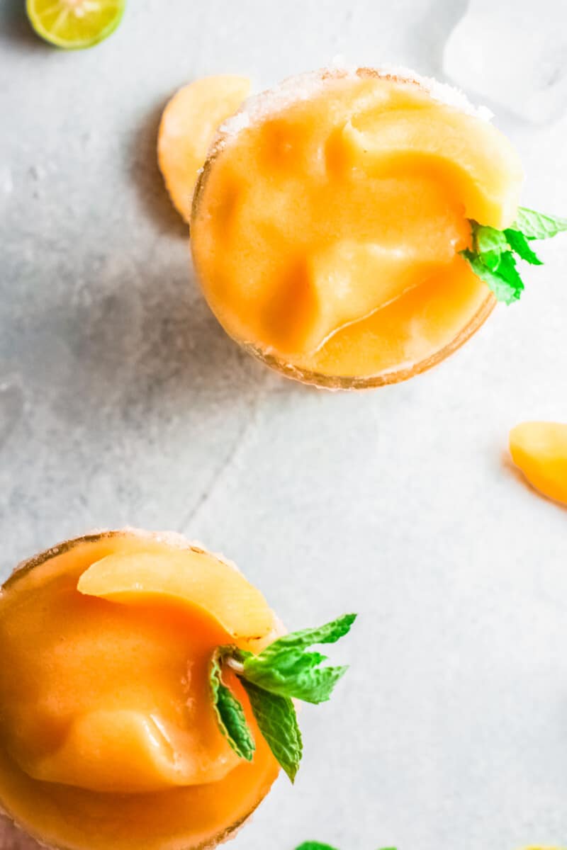 overhead two glasses of frozen peach margaritas