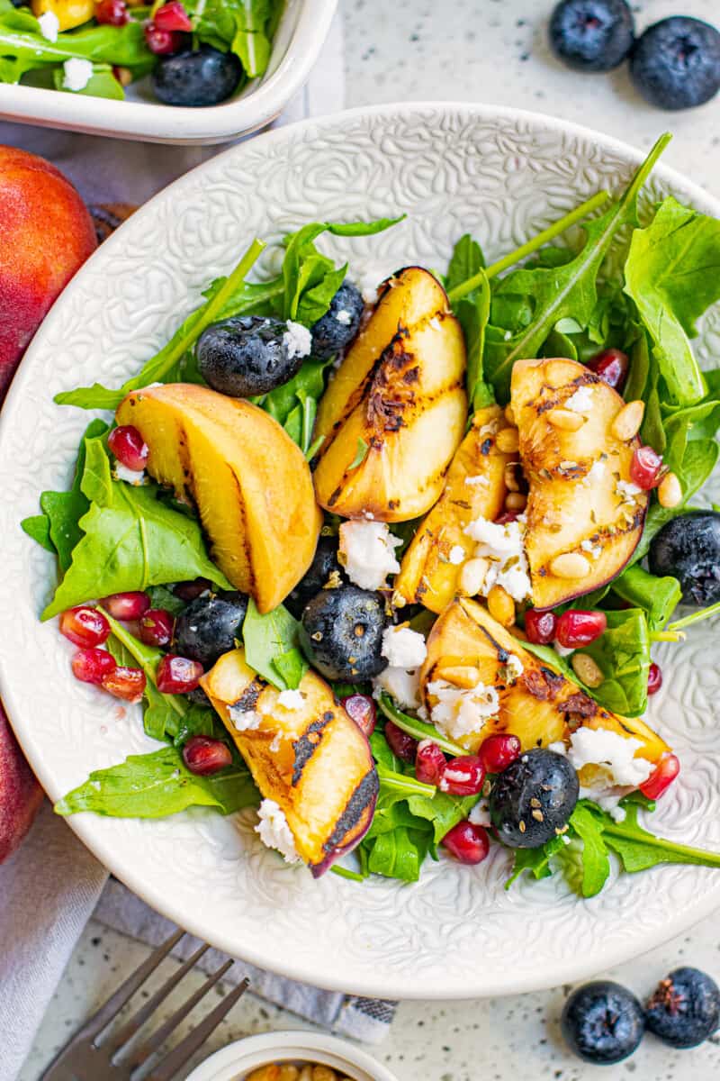 grilled peach salad with feta in bowl