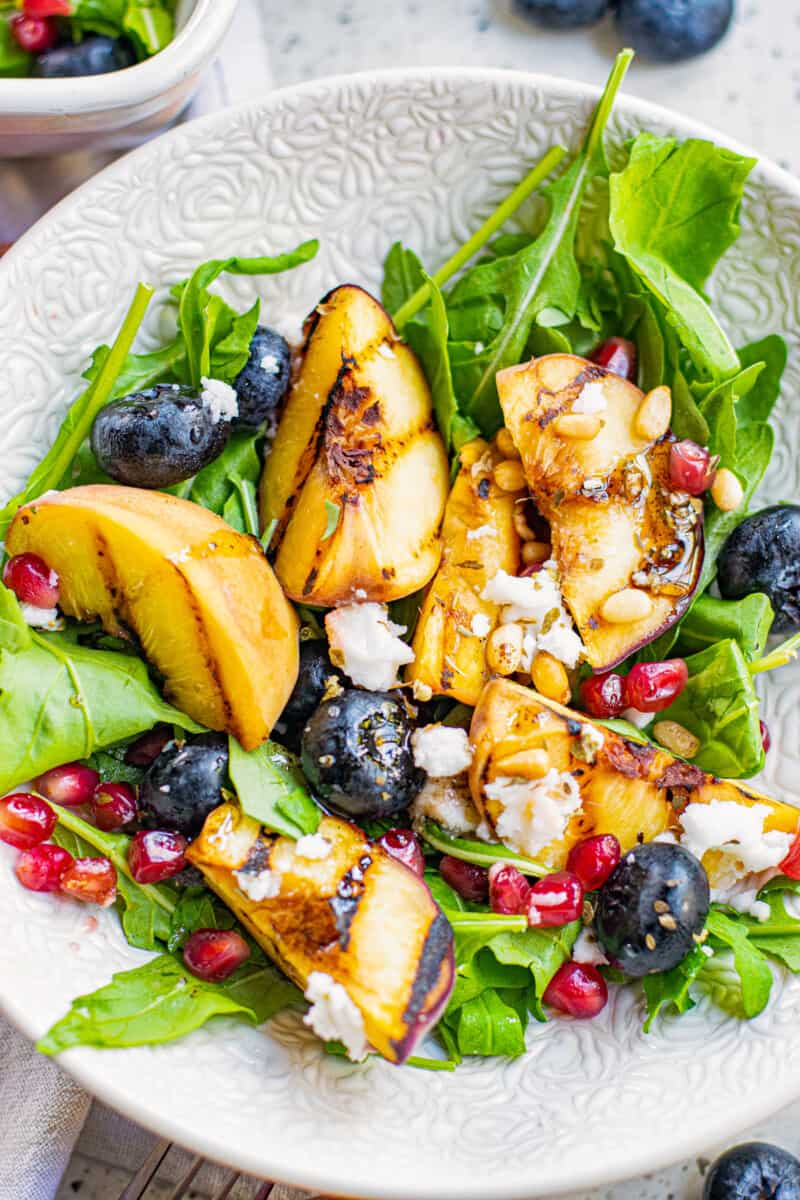 grilled peach salad with feta in bowl