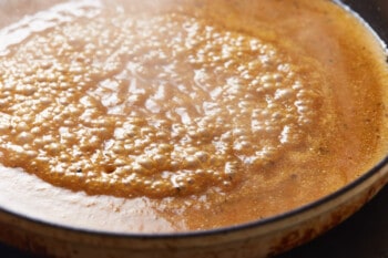 sauce for honey mustard pork chops simmering in a pan.