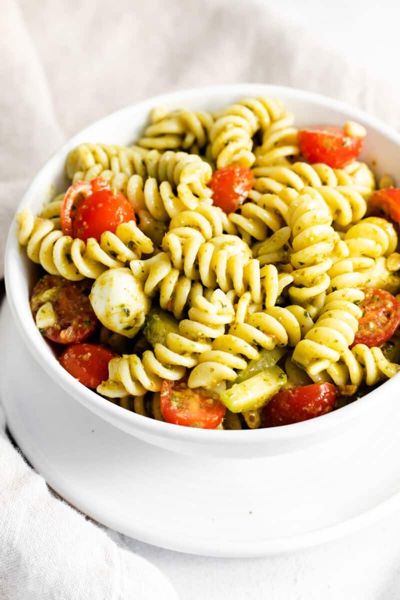 pesto pasta salad in white bowl