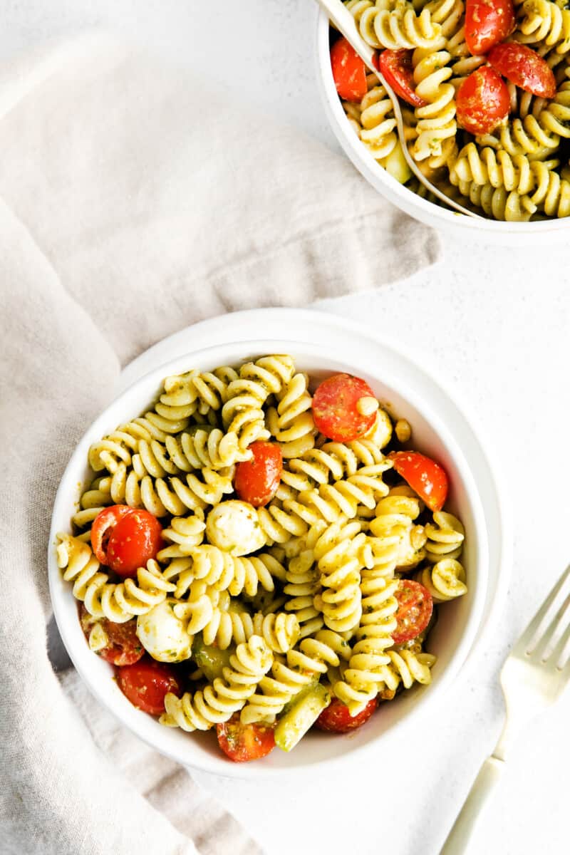 overhead pesto pasta salad in white bowl