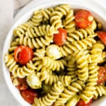 overhead pesto pasta salad in white bowl