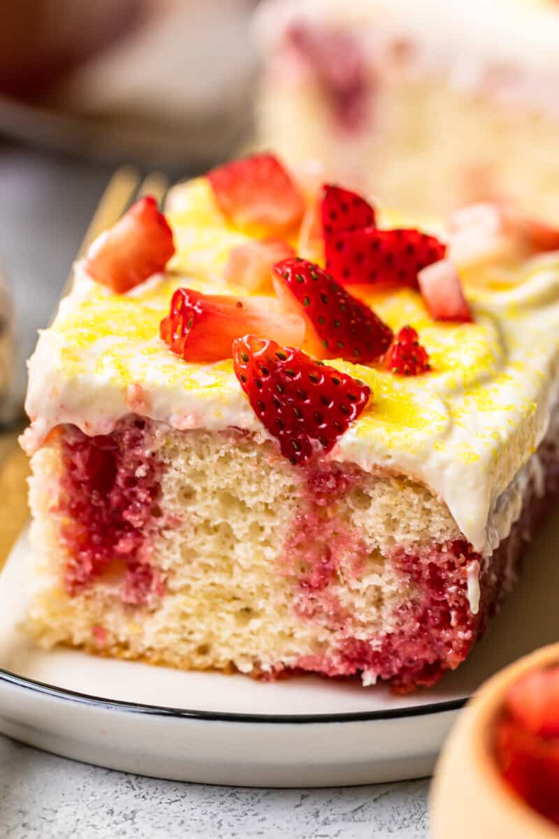 up close slice of strawberry lemonade poke cake