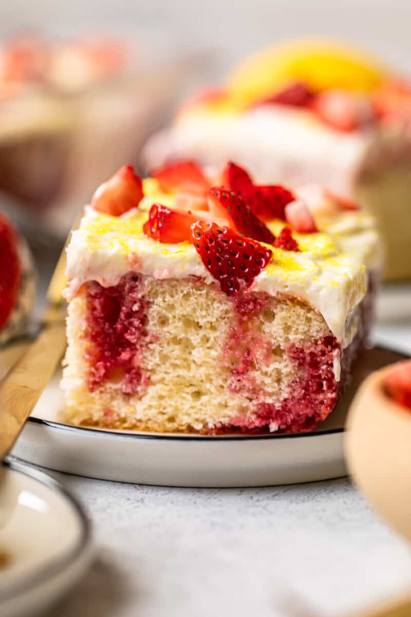 slice of strawberry lemonade poke cake