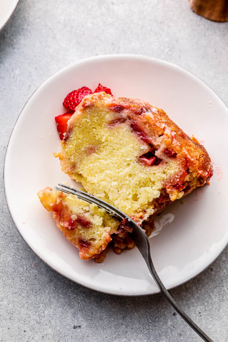 slice of glazed strawberry pound cake with silver fork