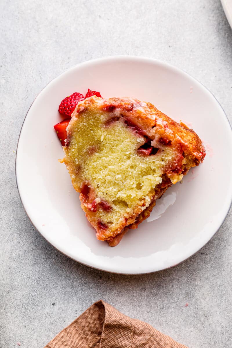 slice of glazed strawberry pound cake on white plate