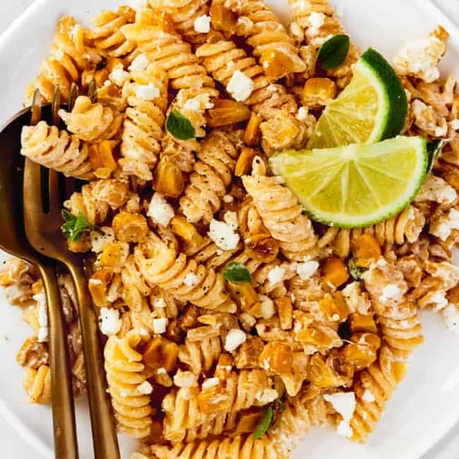 up close white plate with mexican street corn pasta salad