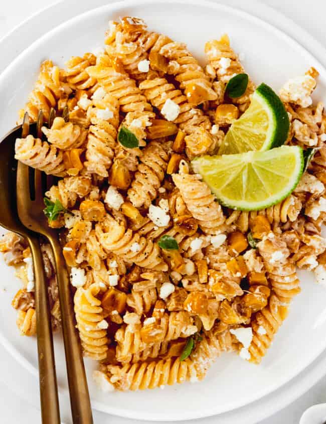 up close white plate with mexican street corn pasta salad