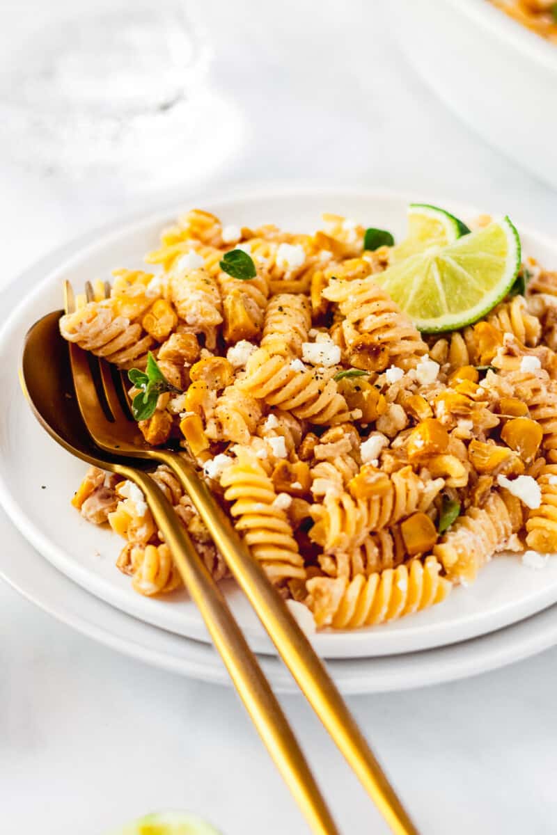 white plate with mexican street corn pasta salad