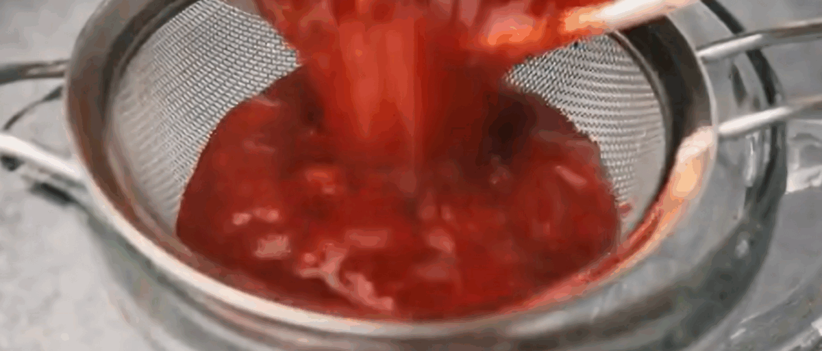 Straining the strawberry filling. 