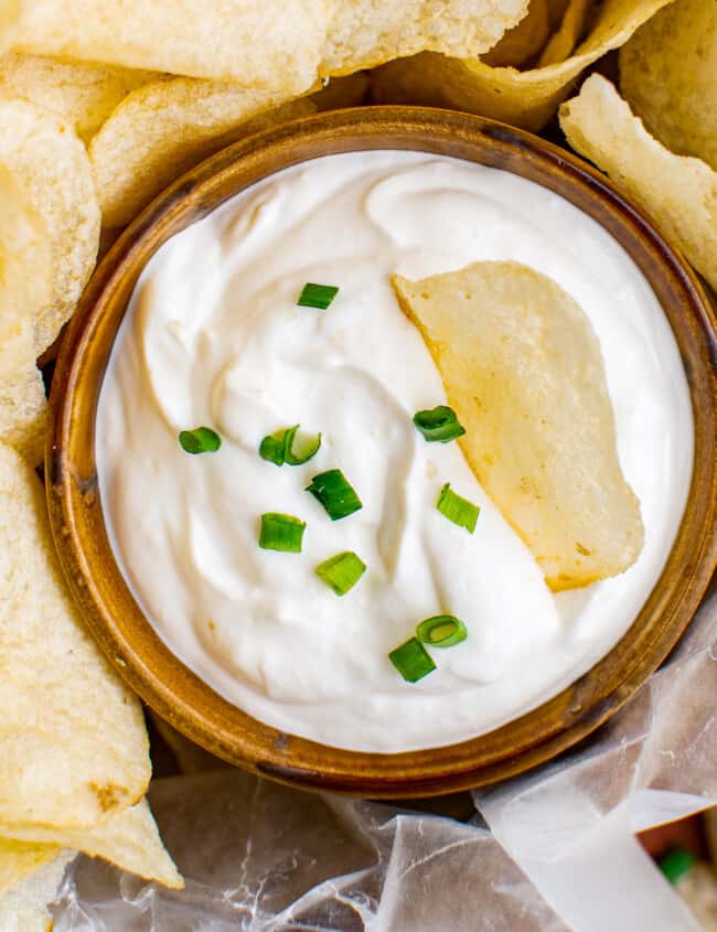 up close chip dip in a bowl garnished with chives