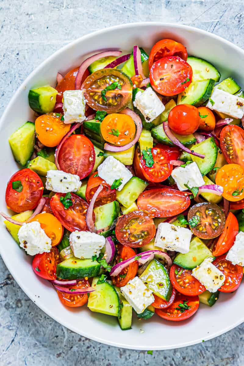 cucumber tomato salad in bowl with feta