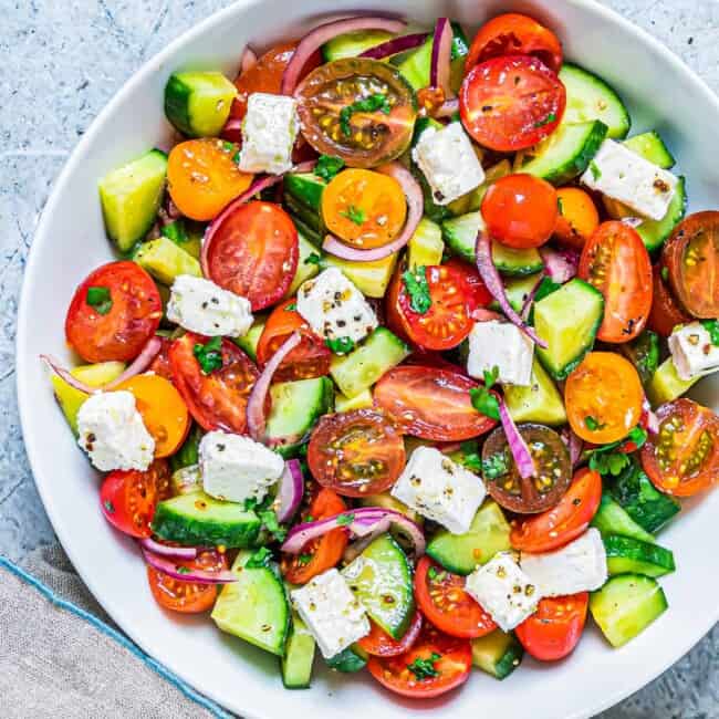 white bowl filled with cucumber tomato salad