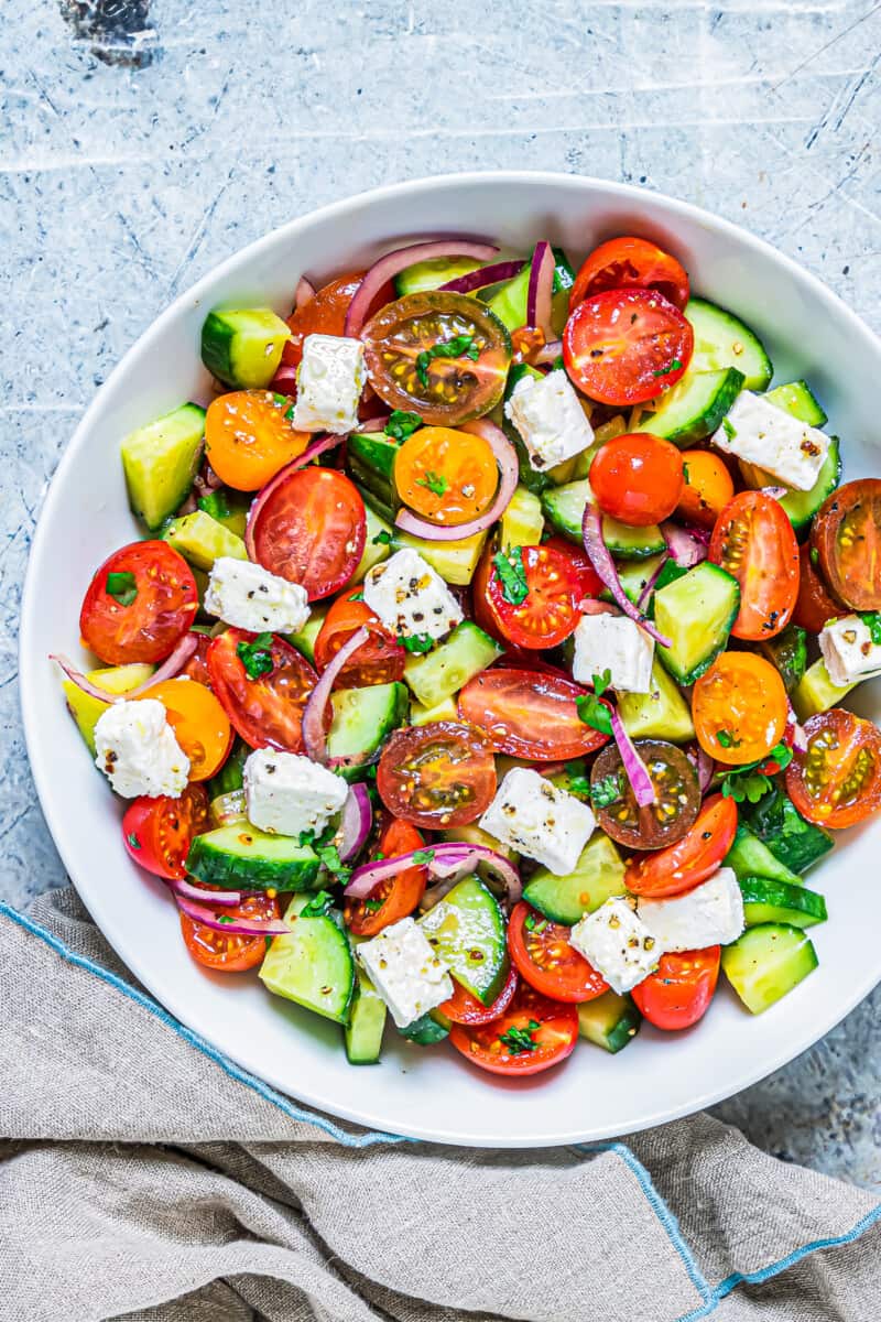 white bowl filled with cucumber tomato salad