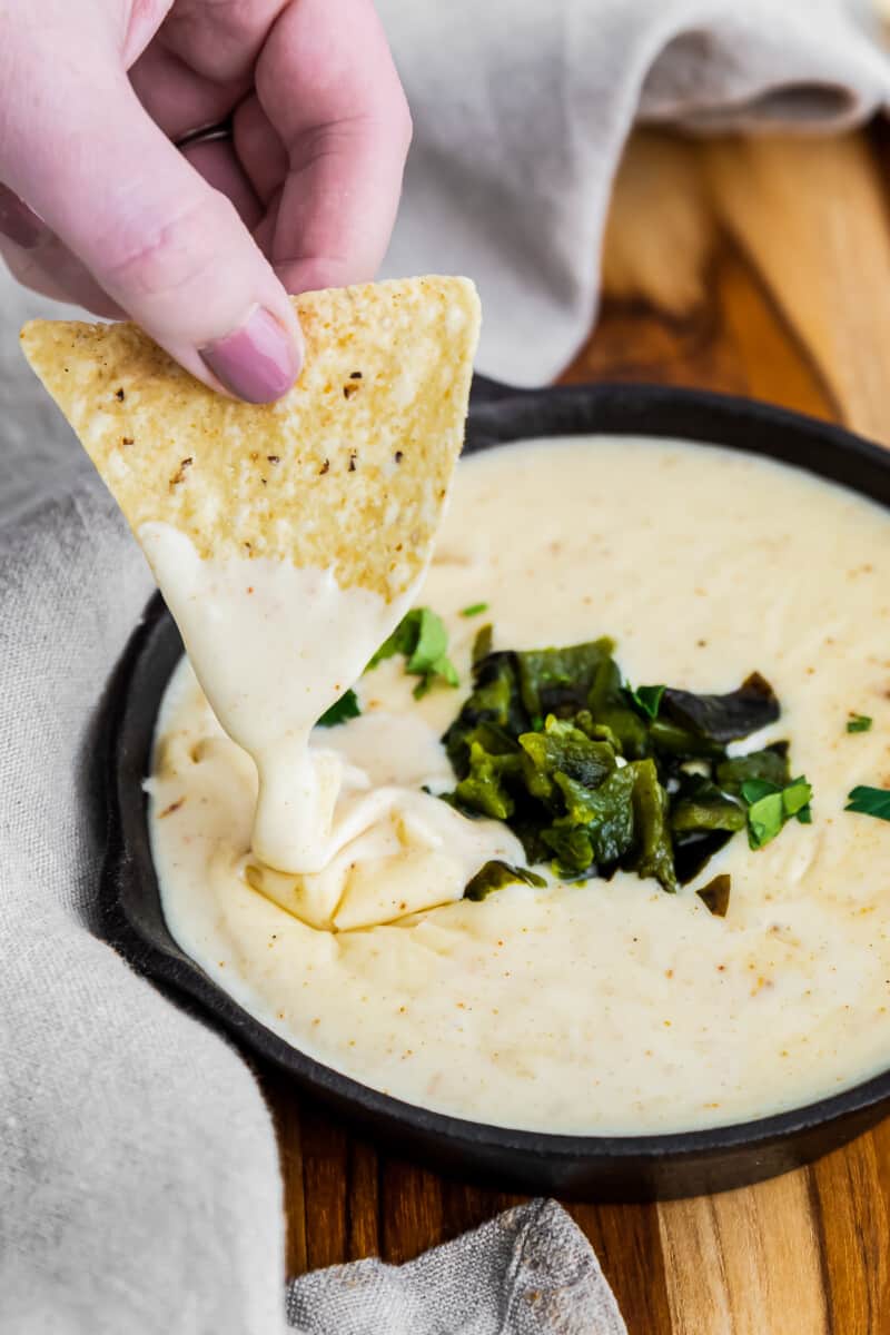 dipping chip in poblano queso