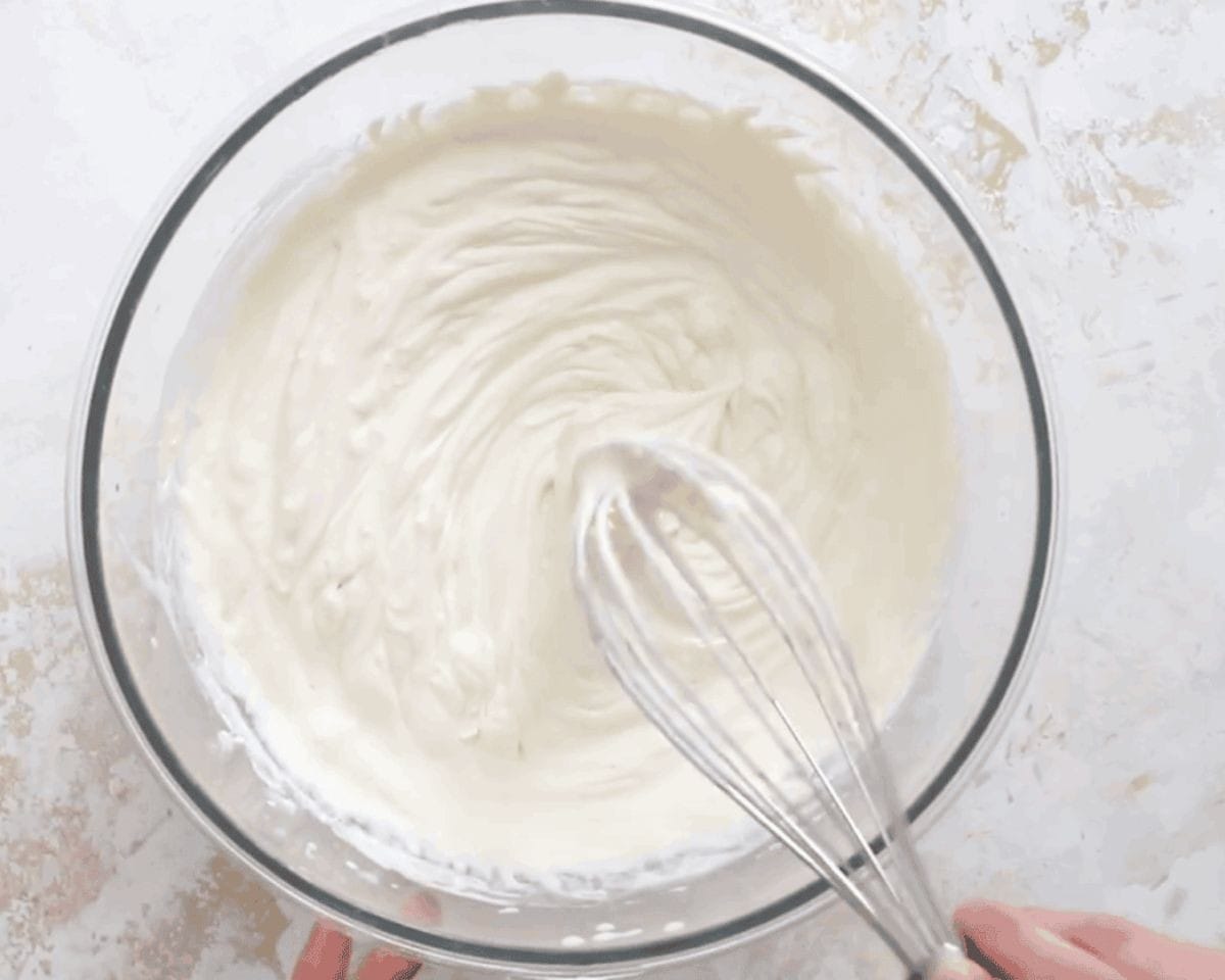 Adding mascarpone to the whipping cream.