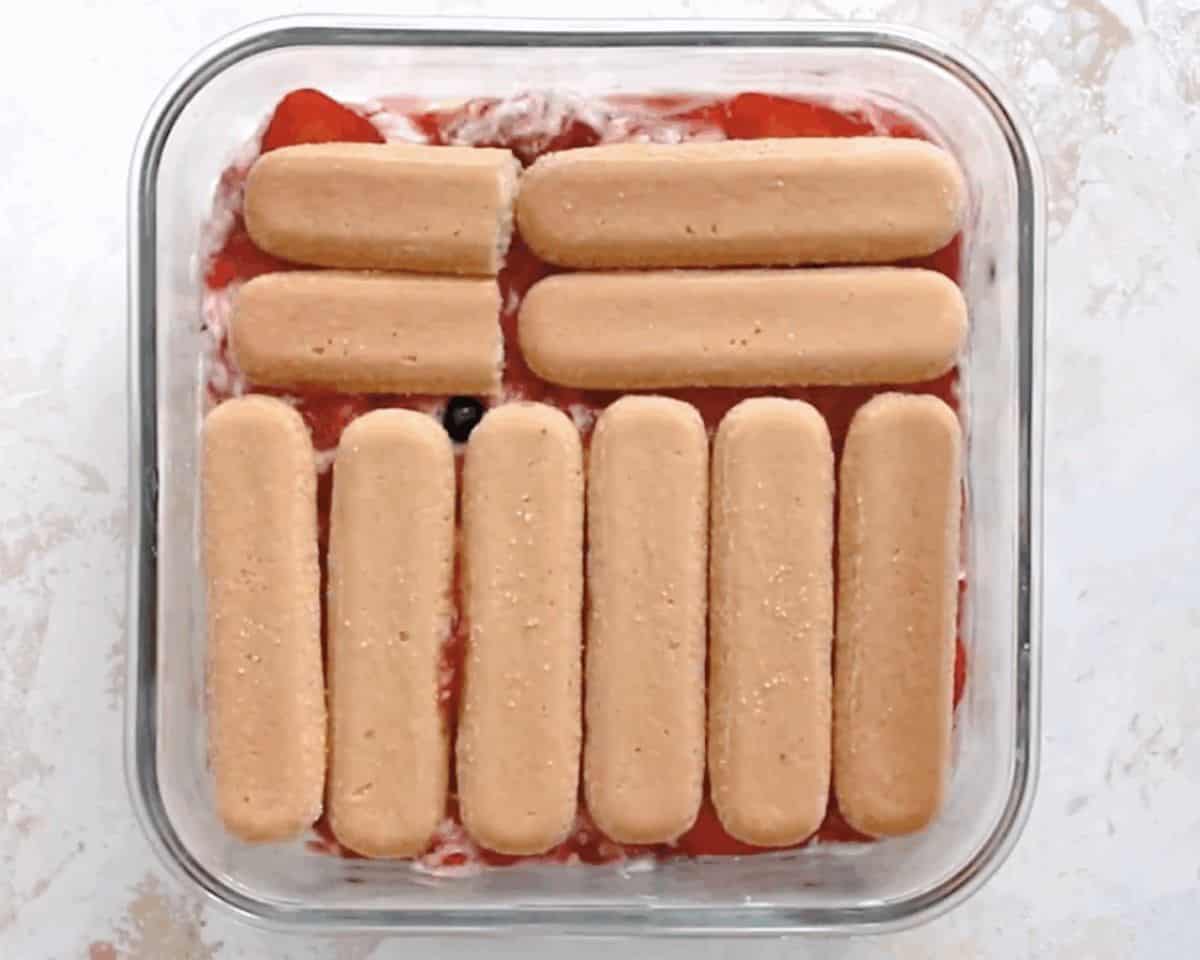 A layer of lady fingers over the fruit layer.