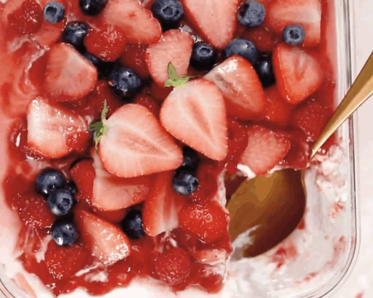 Topping the tiramisu with a final layer of fruit.