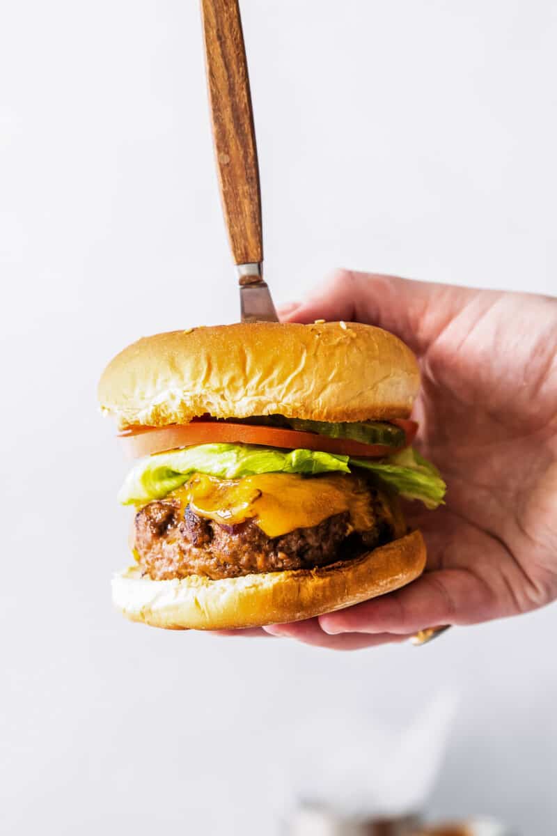 holding up air fried bbq burger