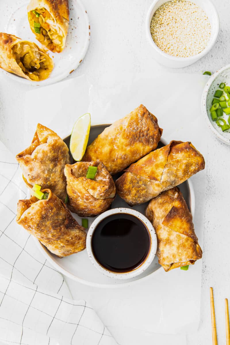 overhead air fryer egg rolls next to bowl of soy sauce