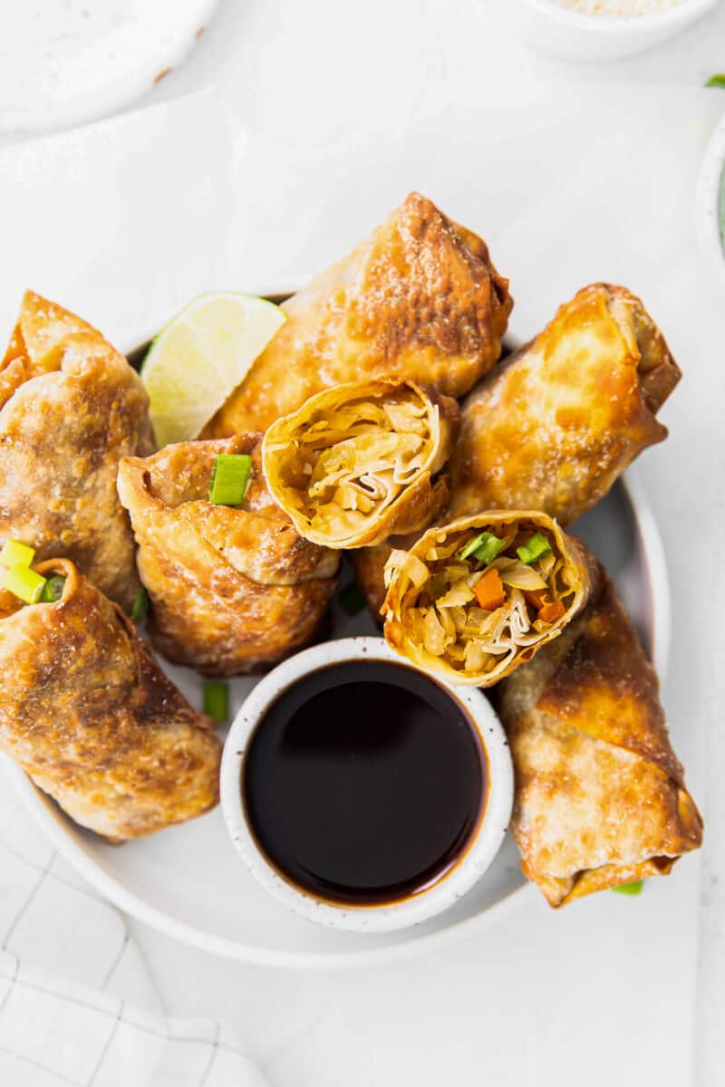 overhead air fryer egg rolls next to bowl of soy sauce