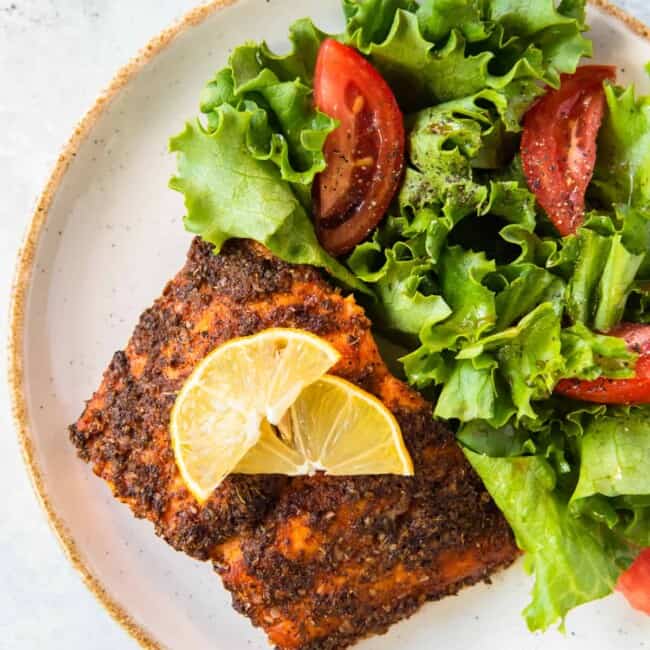 air fried salmon on plate with salad