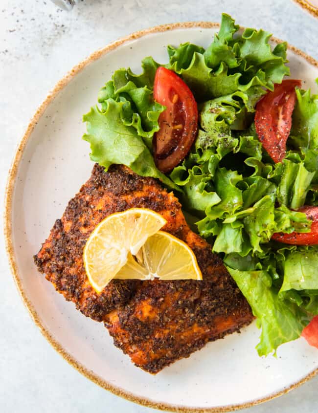 air fried salmon on plate with salad