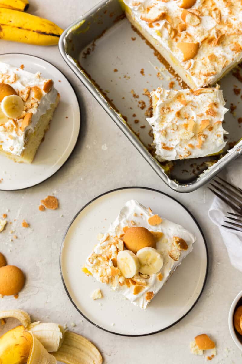 banana pudding poke cake on plates and in baking dish