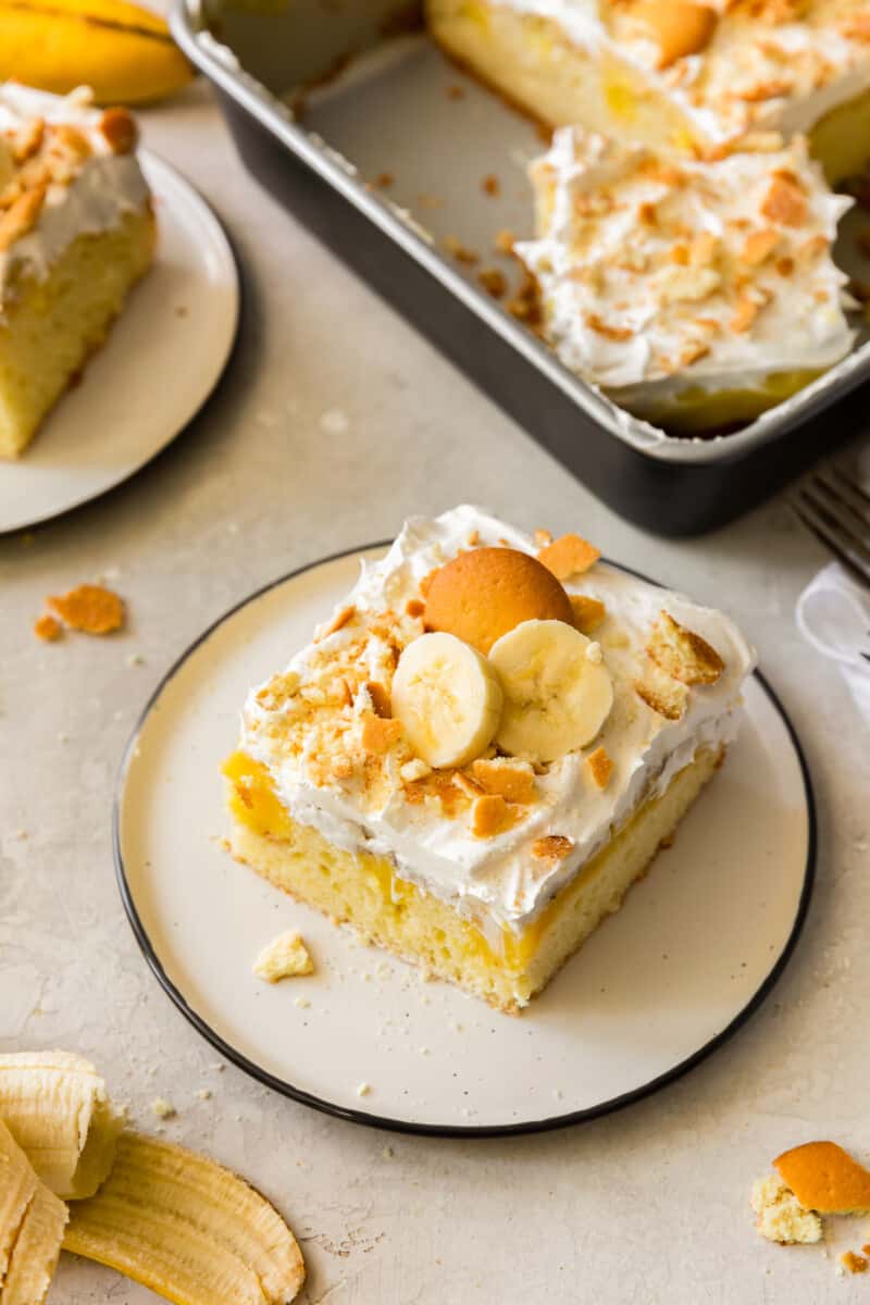 slice of banana pudding poke cake with vanilla wafers