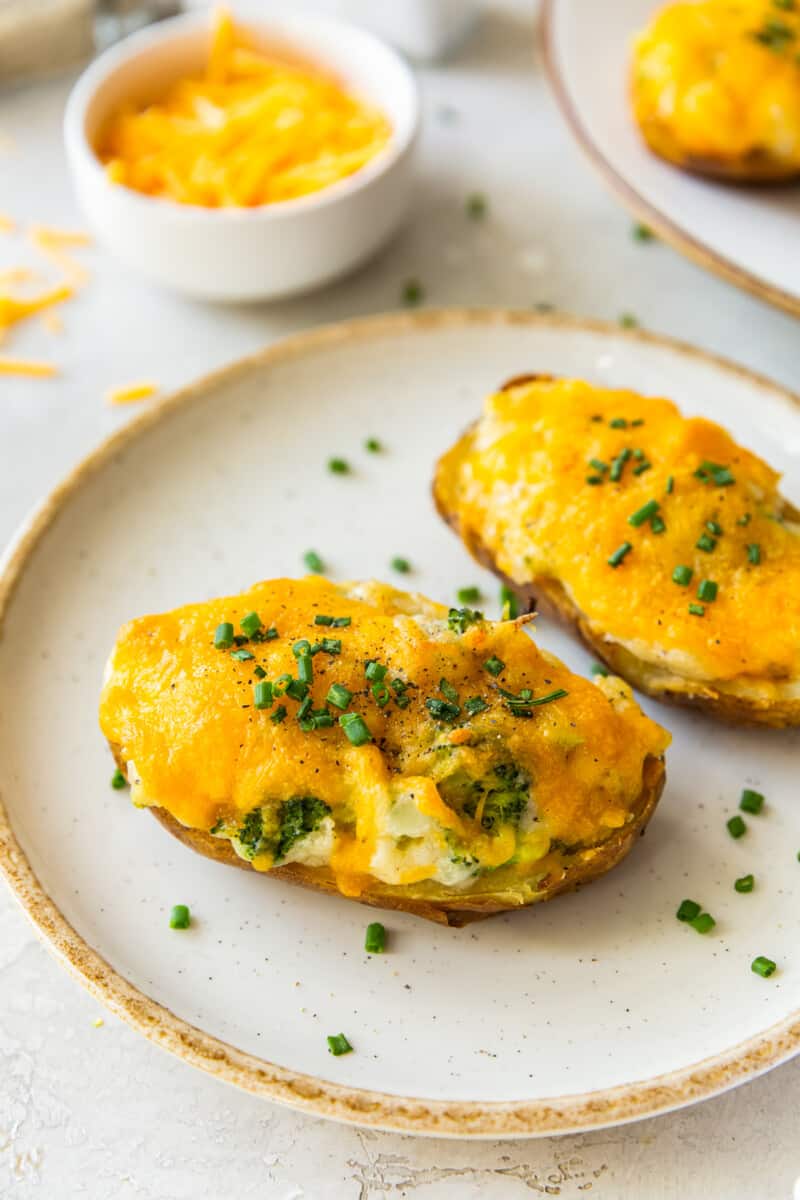 two broccoli cheese twice baked potatoes on white plate