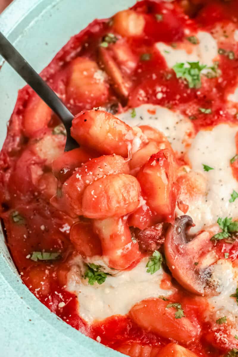 up close cheesy baked gnocchi in baking dish