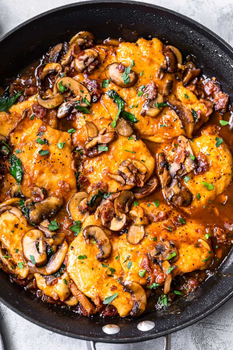 Cooked chicken marsala in a skillet from an overhead angle