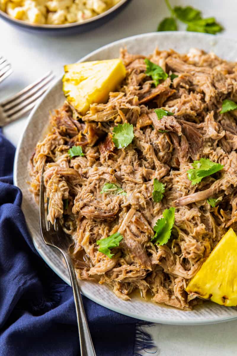 overhead plate of kalua pork on plate with pineapple slices